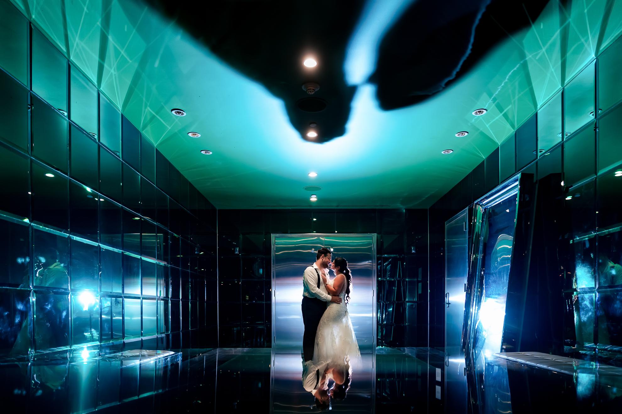 A bride and groom standing in an elevator.