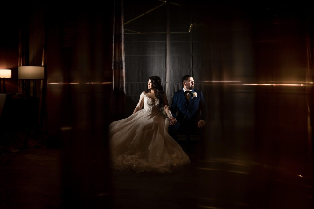 ThomasKim Photography Los Angeles Wedding Photographer J & C, a bride and groom, posing in a dark room.