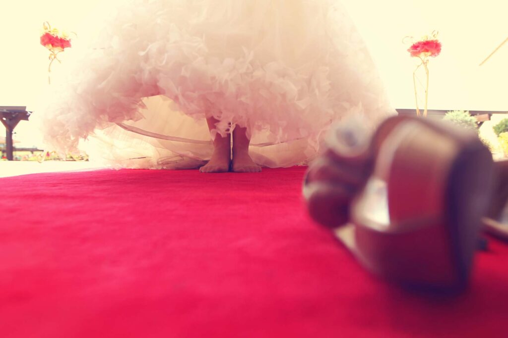 ThomasKim Photography Los Angeles Wedding Photographer A woman in a wedding dress standing on a red carpet.