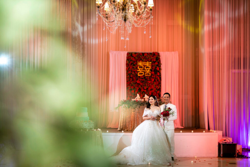 ThomasKim_photography A bride and groom standing in front of a chandelier