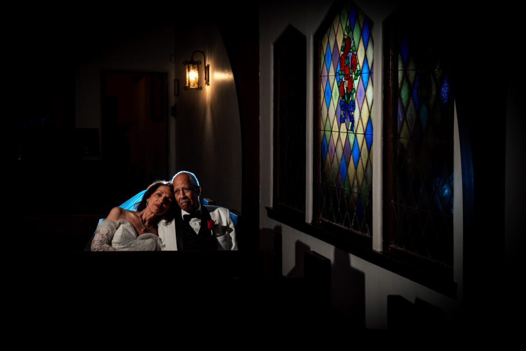 ThomasKim Photography Los Angeles Wedding Photographer Bride and groom sit closely together in a dimly lit room