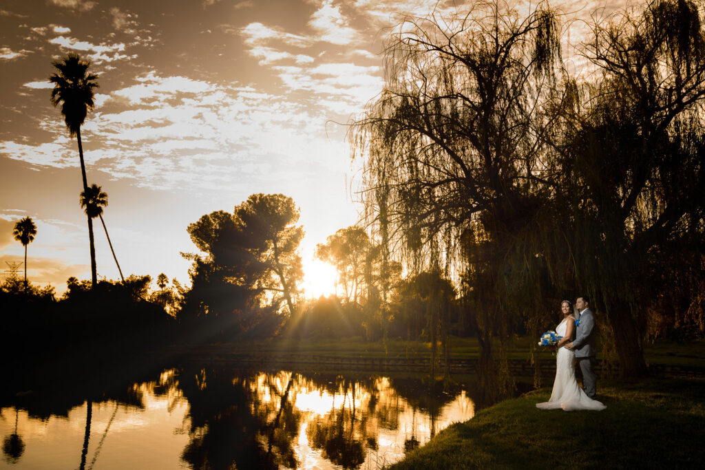 ThomasKim_photography Los Angeles Wedding Photography: A Guide to Capturing Your Big Day in the City of Angels with a bride and groom standing next to a pond at sunset.|ThomasKim_photography A breathtaking bride and groom kissing in a train station
