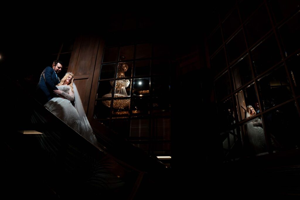 ThomasKim Photography Los Angeles Wedding Photographer A celebrity-inspired bride and groom standing on an escalator at night in Los Angeles.