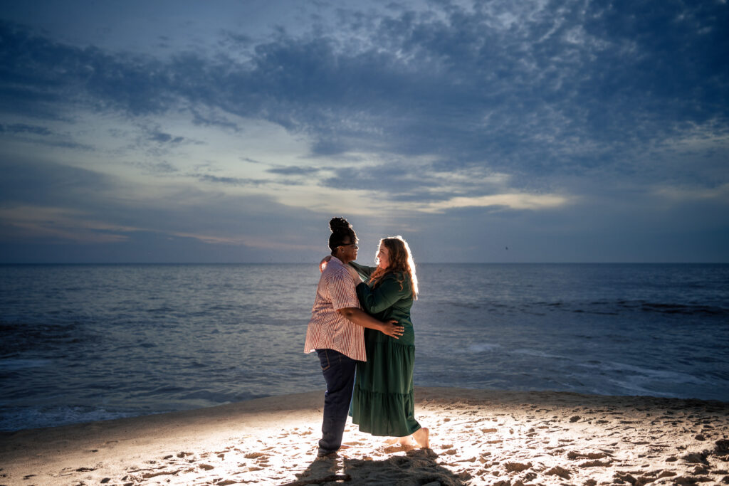 ThomasKim Photography Los Angeles Wedding Photographer Two people stand embracing on a beach at sunset