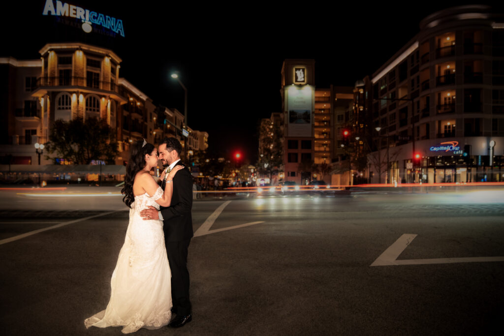 ThomasKim Photography Los Angeles Wedding Photographer A bride and groom standing in the middle of the street at night