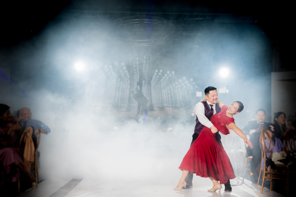 ThomasKim_photography A couple dancing in a smoke-filled room with presence and passion.