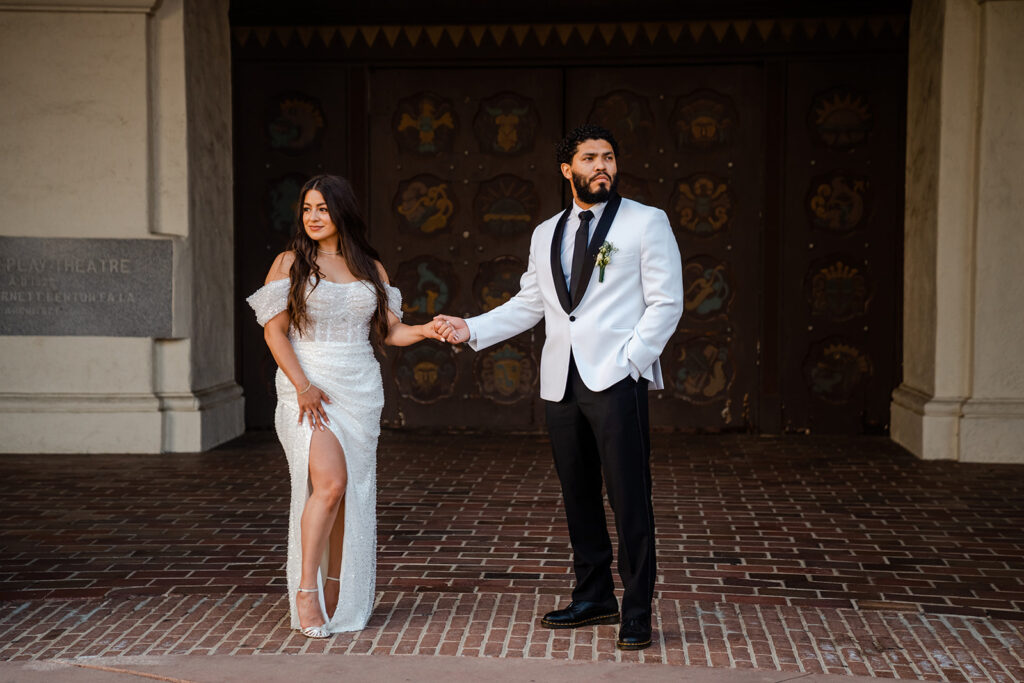 ThomasKim_photography A bride and groom standing in front of a building