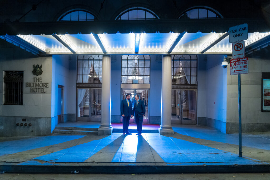 ThomasKim_photography Two men standing in front of a building at night