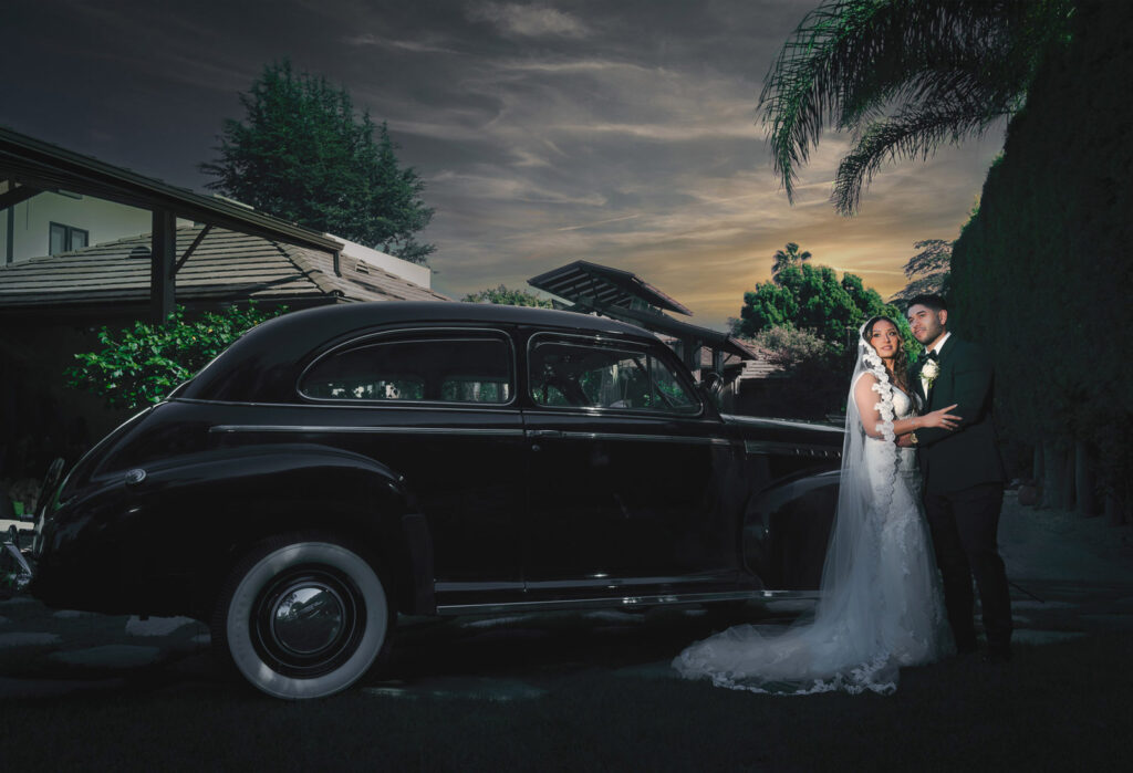 ThomasKim Photography Los Angeles Wedding Photographer A bride and groom stand beside a vintage black car